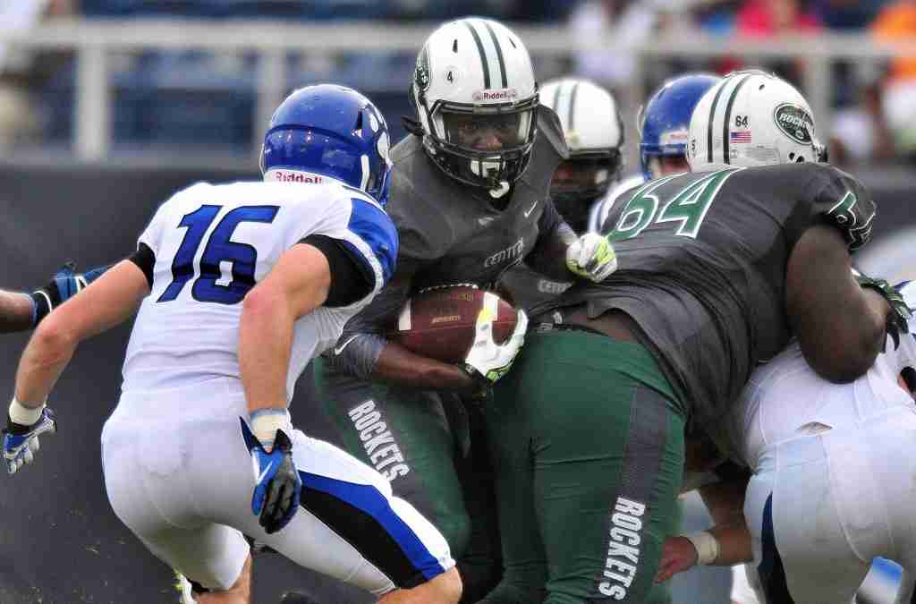 NOT SO FAST: Miami Central’s Anthony Jones (No. 4) looks for running room as Washington state Bothell’s Tongi Langi (No. 16) prepares to make the tackle in the second quarter of State Championship Bowl Series game 2 on Saturday at FAU stadium in Boca Raton
