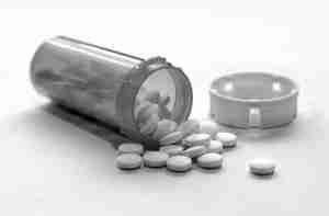 95435042 - opioid crisis - open bottle of prescription painkiller pills